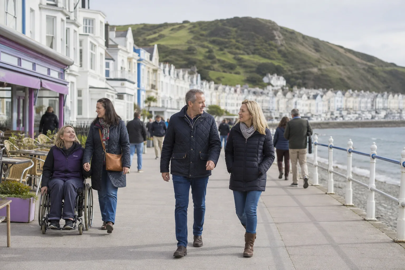 People talking together at a relaxed social gathering on the Isle of Man