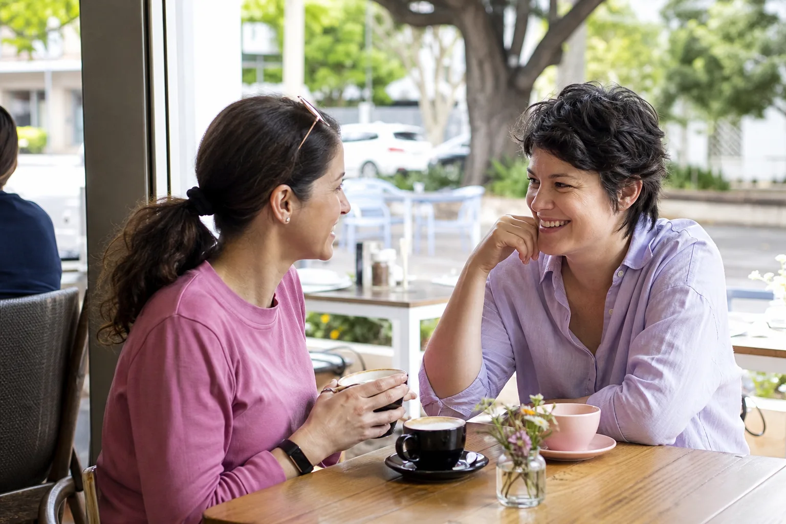 Woman meeting a man for coffee beside Douglas seafront